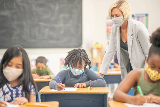istock Elementary school children wearing face masks in class 1270134364