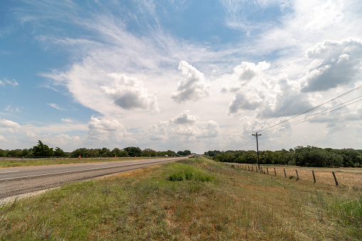 View of Texas highway With Farm Land on the Side of the Road and Constructions cones