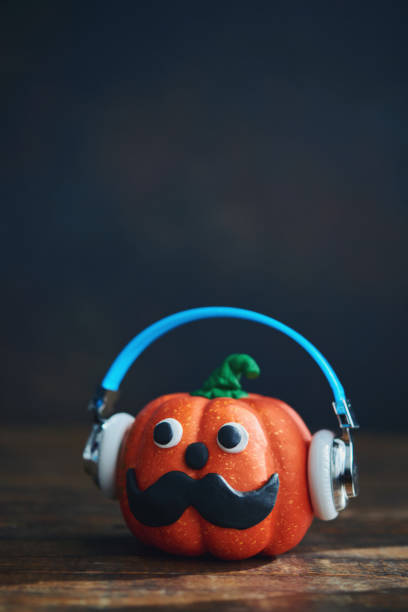 istock Cute handmade pumpkin with handlebar mustache and headphones 1270145217