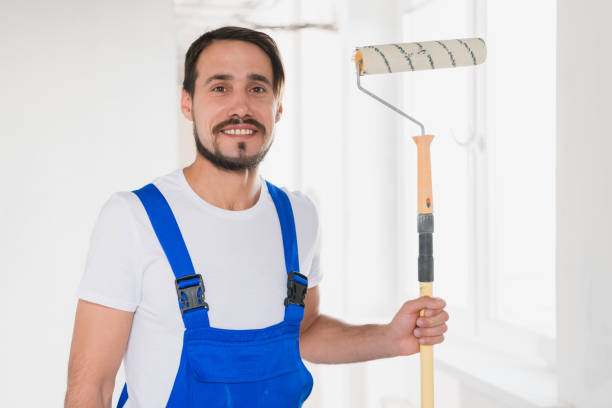istock The painter holds a roller in his hand, looks at the camera and smiles 1270146256