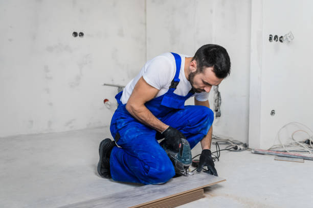 istock Bearded foreman sawing a wooden board with a jigsaw 1270146288
