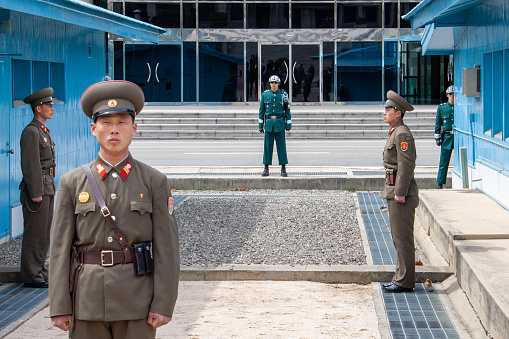 Panmunjom, North Korea - Apr 14, 2010: The row of concrete blocks in the middle divides the two Koreas, with sand on the north side and gravel on the south.