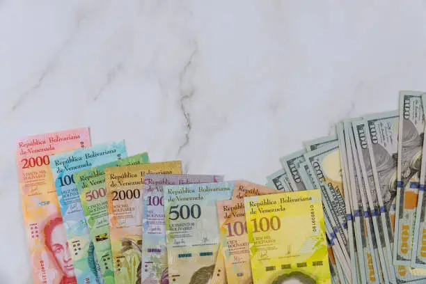 Money American dollar bills and series of banknotes with different paper bills currency Venezuelan Bolivar