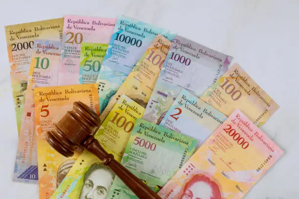 Judges gavel law Venezuelan Bolivar banknote with different currency paper bills. law justice office.