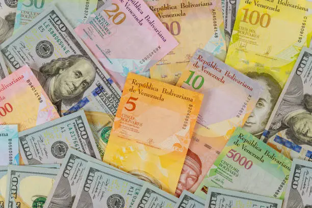 Money american hundred dollar bills Venezuela economic of banknotes with different paper bills currency Venezuelan Bolivar,