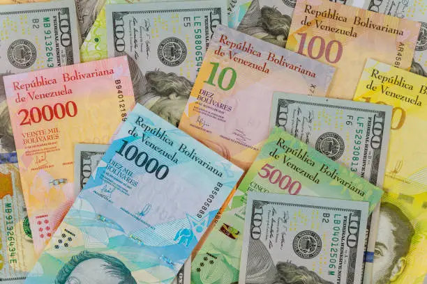 Venezuelan Bolivar banknote with different currency paper bills.