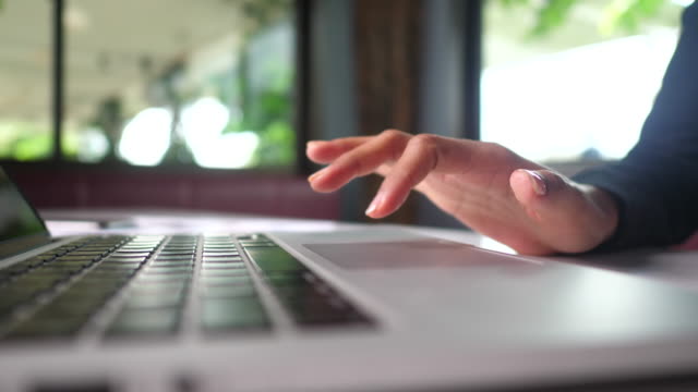 woman's hand uses the trackpad