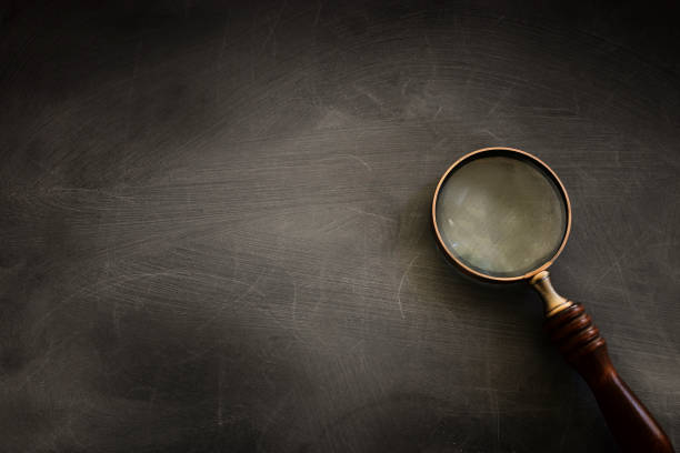 istock vintage magnifying glass with wooden handle over chalkboard background. top view, flat lay 1270150409
