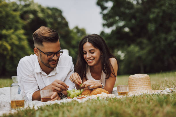 istock Young couple having picnic in nature. 1270150609