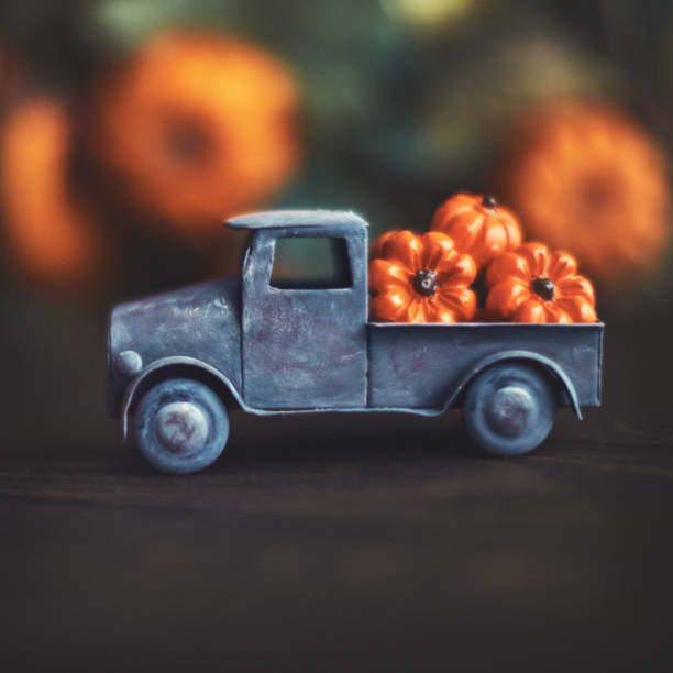 istock Fall background with little truck carrying pumpkins 1270150616