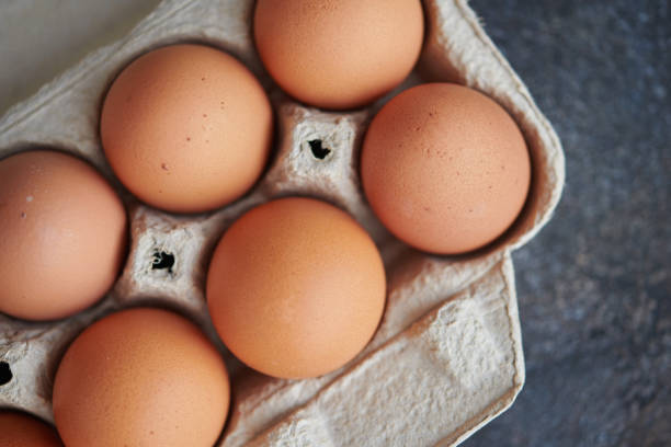 istock Still life image of brown eggs in cardboard egg carton 1270152348