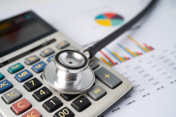 istock Stethoscope with calculator on chart graph paper, finance, account, statistic, analytic economy Business concept. 1270154817