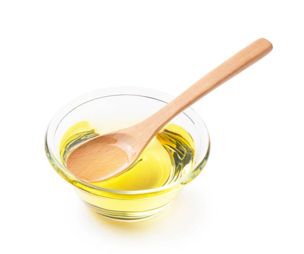 istock Vegetable oil and wooden spoon on a white background 1270156161