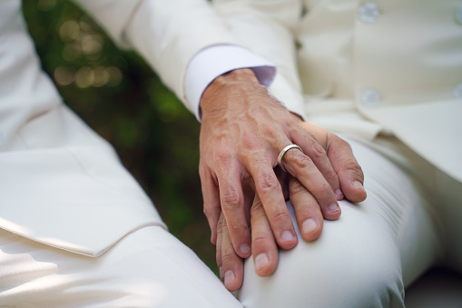 closed up of man hands with wedding ring on man hands in concept of LGBT gay or bisexual wedding ceremony