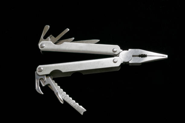 istock Multi-purpose steel tool on a black background, pocket knife and multi-tool for domestic use. 1270172894