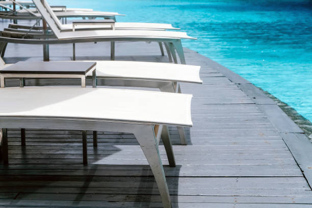istock Many white chaise lounge by the pool 1270173537
