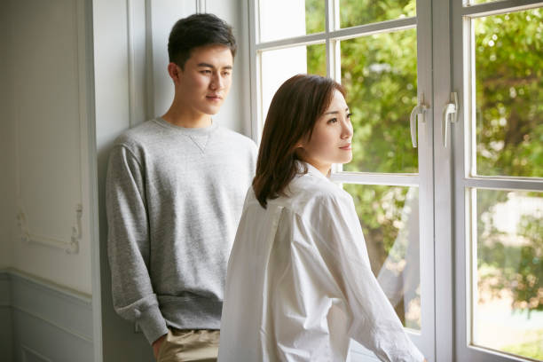 istock young asian couple staying at home 1270179281