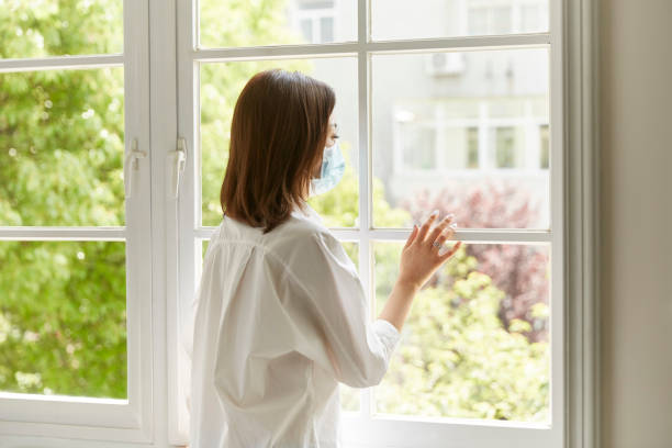 istock young asian woman looking through window 1270179301