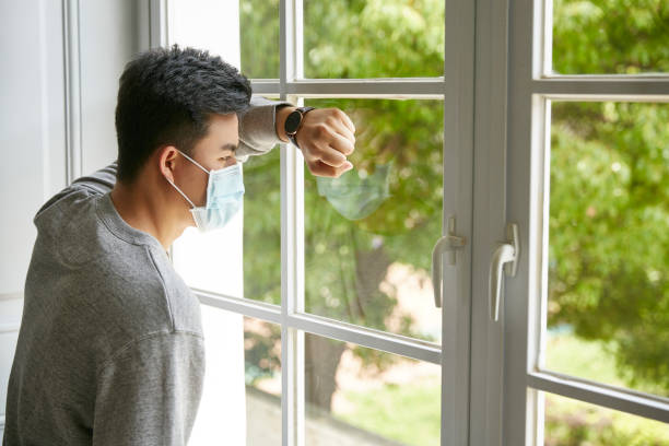 young asian man in quarantine staying at home