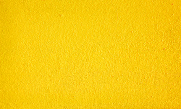 istock Colorful yellow paint texture on cement wall abstract background 1270179988