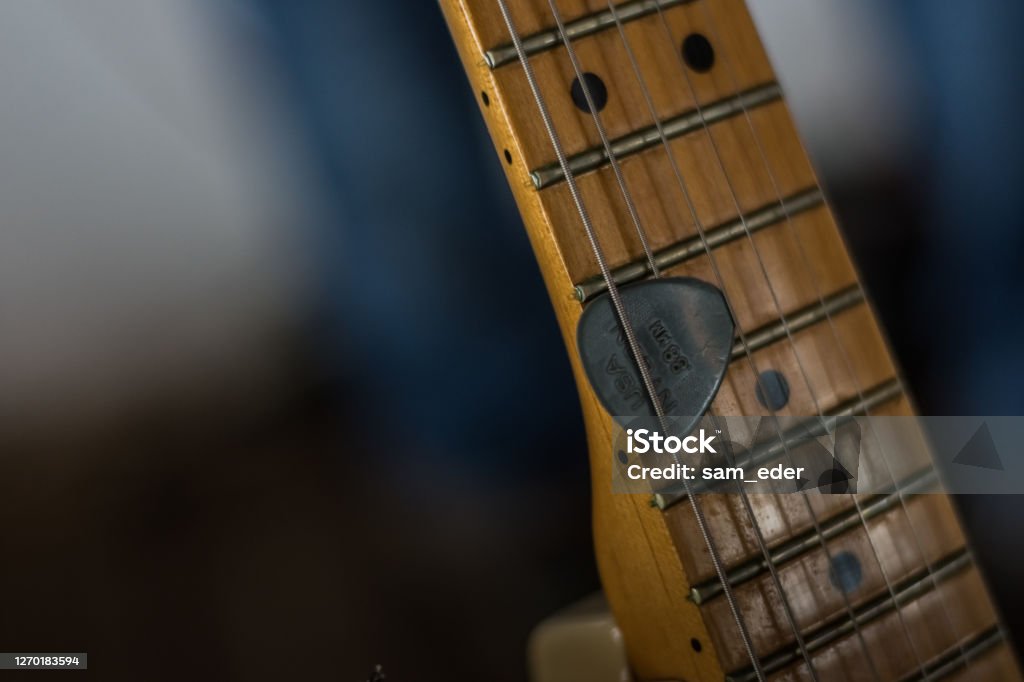 guitar with a pick detailed view guitar with a pick detailed view at a concert Color Image Stock Photo