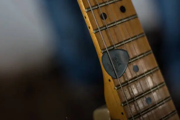 guitar with a pick detailed view at a concert