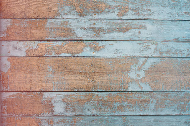 istock Wooden background with a texture of cracked blue paint, with a gradient 1270186310