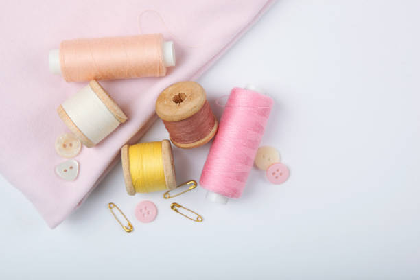 istock different sewing accessories on the table. Threads, needles, pins, fabric and sewing scissors close up 1270186471