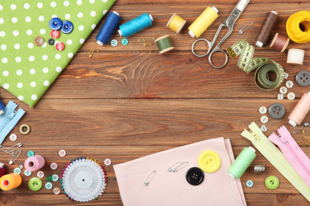 istock different sewing accessories on the table. Threads, needles, pins, fabric and sewing scissors close up 1270186635