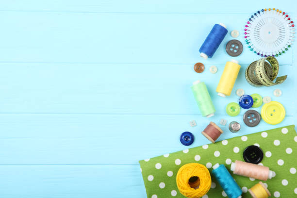 istock different sewing accessories on the table. Threads, needles, pins, fabric and sewing scissors close up 1270186636