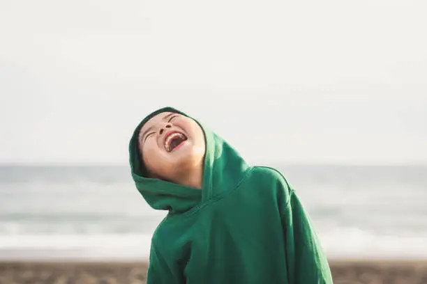 Photo of Portrait of boy standing in the spring beach