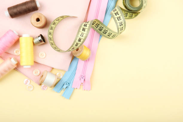 istock different sewing accessories on the table. Threads, needles, pins, fabric and sewing scissors close up 1270188177