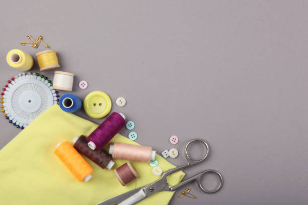 istock different sewing accessories on the table. Threads, needles, pins, fabric and sewing scissors close up 1270188311