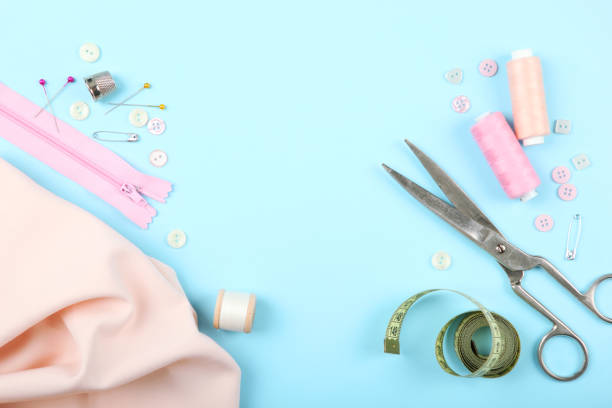 istock different sewing accessories on the table. Threads, needles, pins, fabric and sewing scissors close up 1270188354