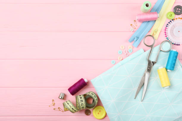 istock different sewing accessories on the table. Threads, needles, pins, fabric and sewing scissors close up 1270188871