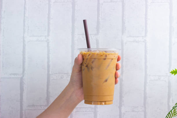 istock Realistic plastic cup on white background. Isolated Mock up Cold beaverage di cut with cliping path. Template block with blank space. Iced coffee on woman hand with black tube. 1270189046
