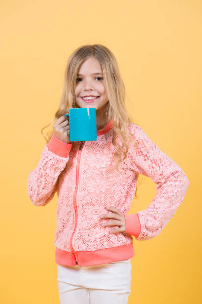 istock Happy child smiling with mug in hand 1270189227