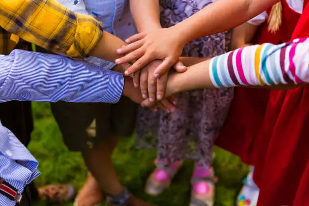 Photo of Kids joining hands together
