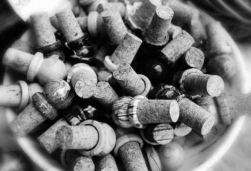 Wine corks as a symbol of excessive alcoholism during quarantine in black and white.