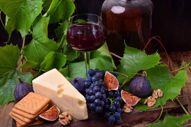 istock Red wine in a glass surrounded by the snacks 1270200098