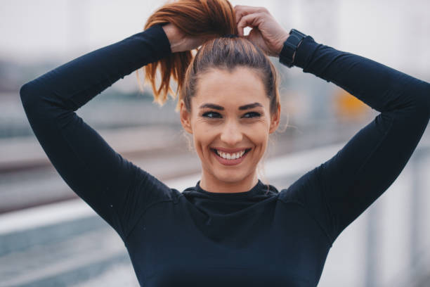 Fittnes woman tying her hair