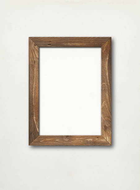 istock Old rustic wooden picture frame hanging on a white wall 1270200350