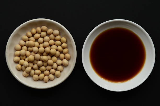 istock Soy sauce and soy beans on black background. 1270205266