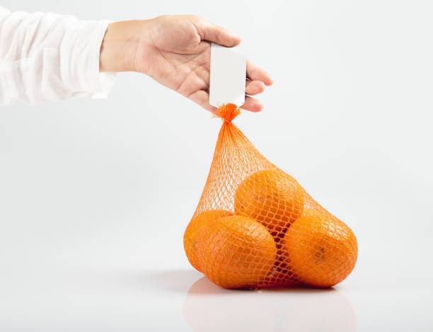 istock Orange juice in reticulated bag on white table 1270207817