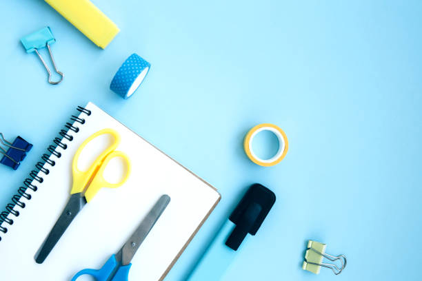 istock White open notebook with blue markers and scotch on a bright blue background 1270209656