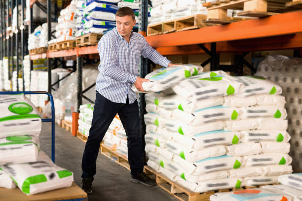istock Man choosing compost soil in plastic bags in hypermarket 1270210005