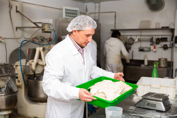 Bakers weigh the dough on the scales