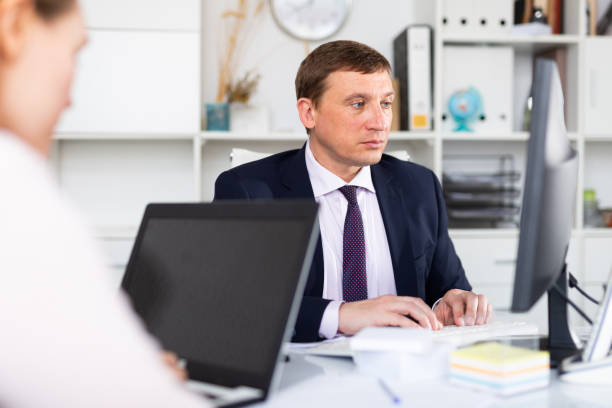 istock Confident businessman concentrated on work with computer in modern office 1270210968