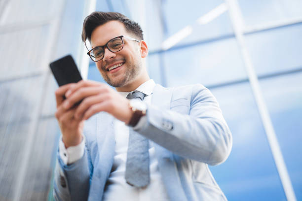 istock Cheerful businessman using mobile phone 1270211344