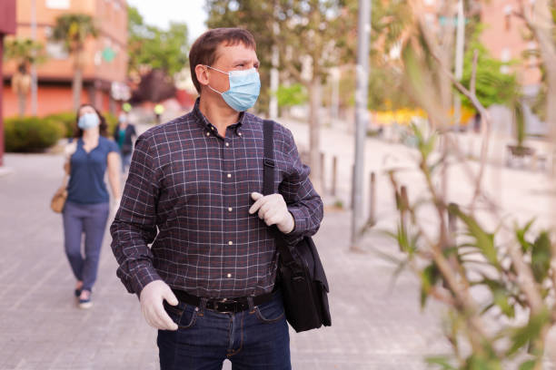istock Man in medical mask walking 1270211605